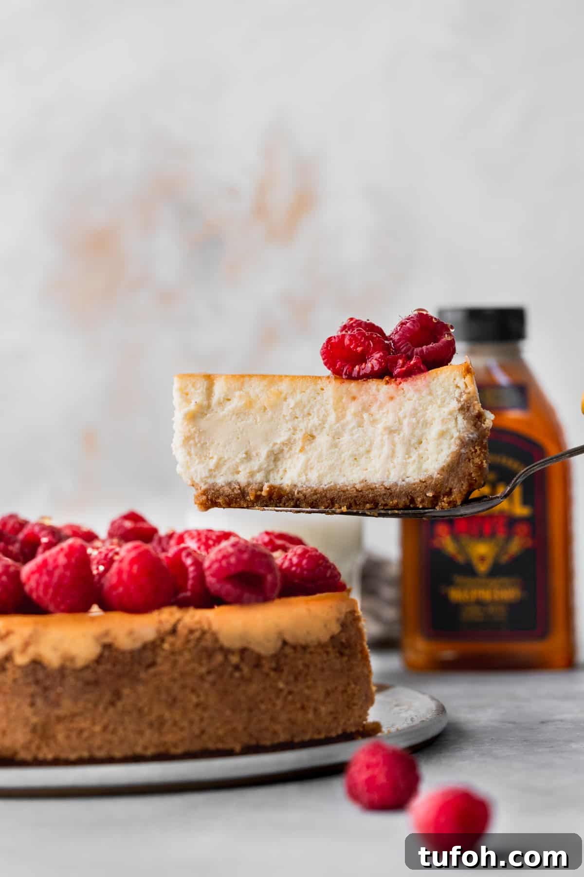 Decadent Honey Cheesecake Recipe with Silky Cream Filling 2 Pulling a slice out of the honey cheesecake.