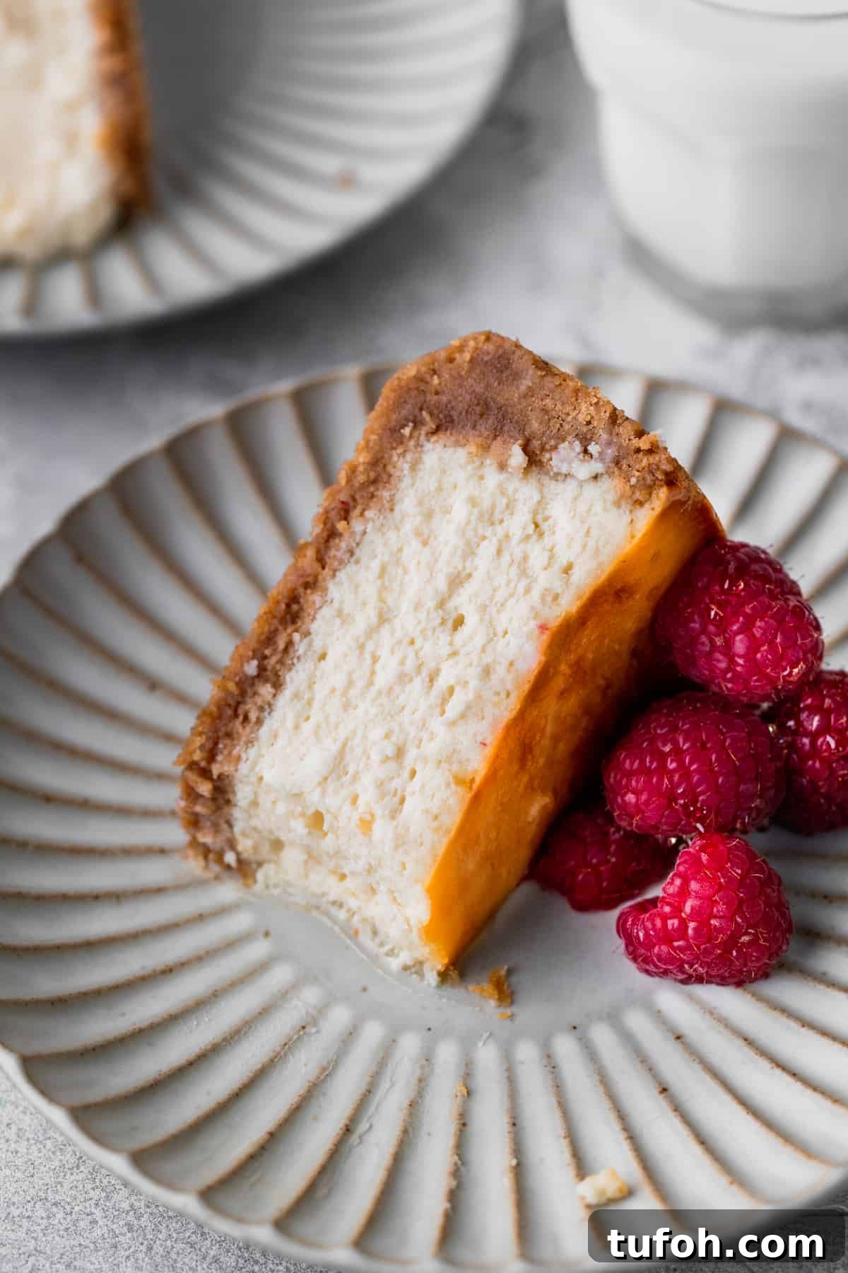 Decadent Honey Cheesecake Recipe with Silky Cream Filling 11 One slice of cheesecake on its side with a bite missing.