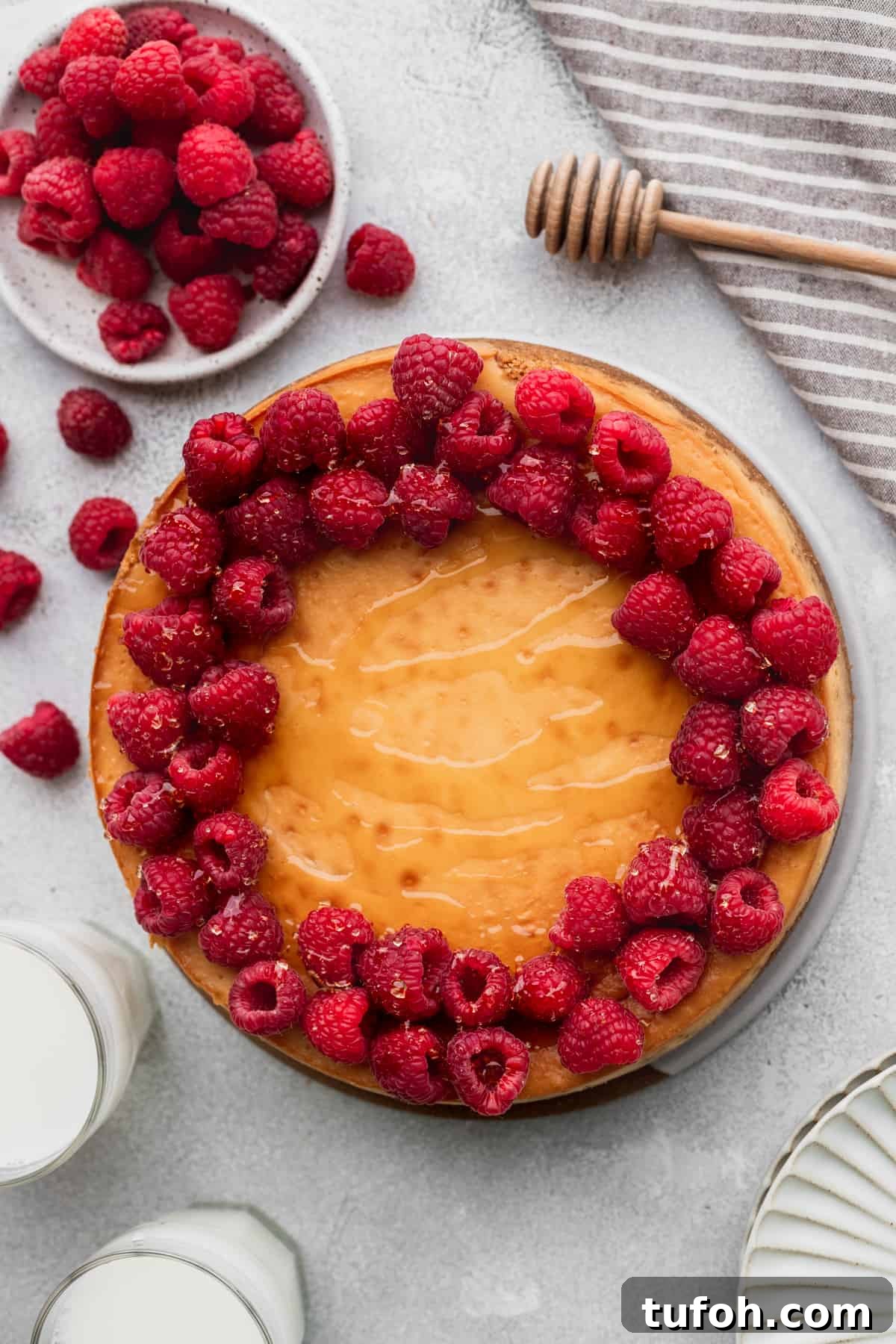 Decadent Honey Cheesecake Recipe with Silky Cream Filling 3 Honey cheesecake with raspberries on top.