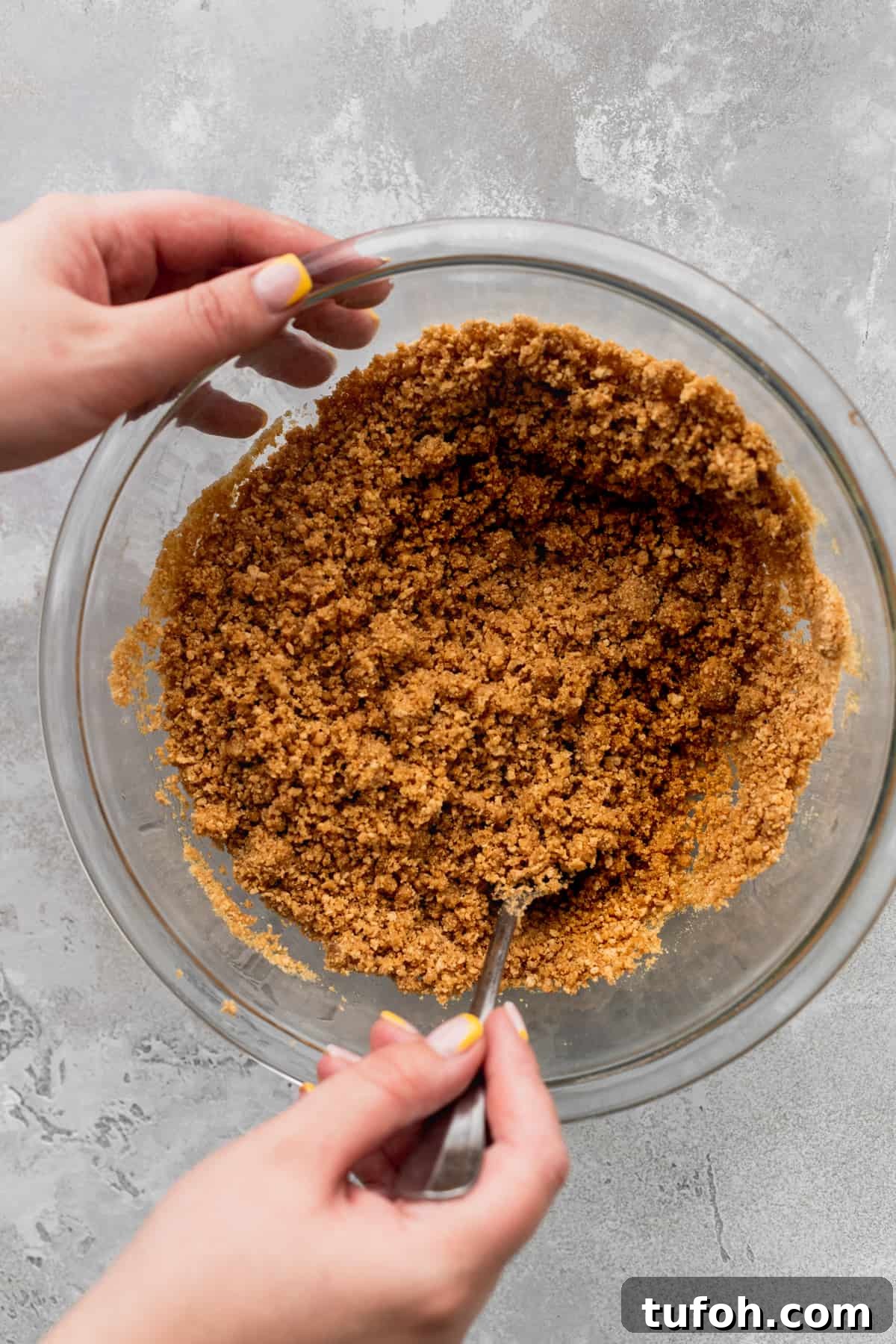 Decadent Honey Cheesecake Recipe with Silky Cream Filling 4 Graham cracker crust crumbs in a glass bowl.