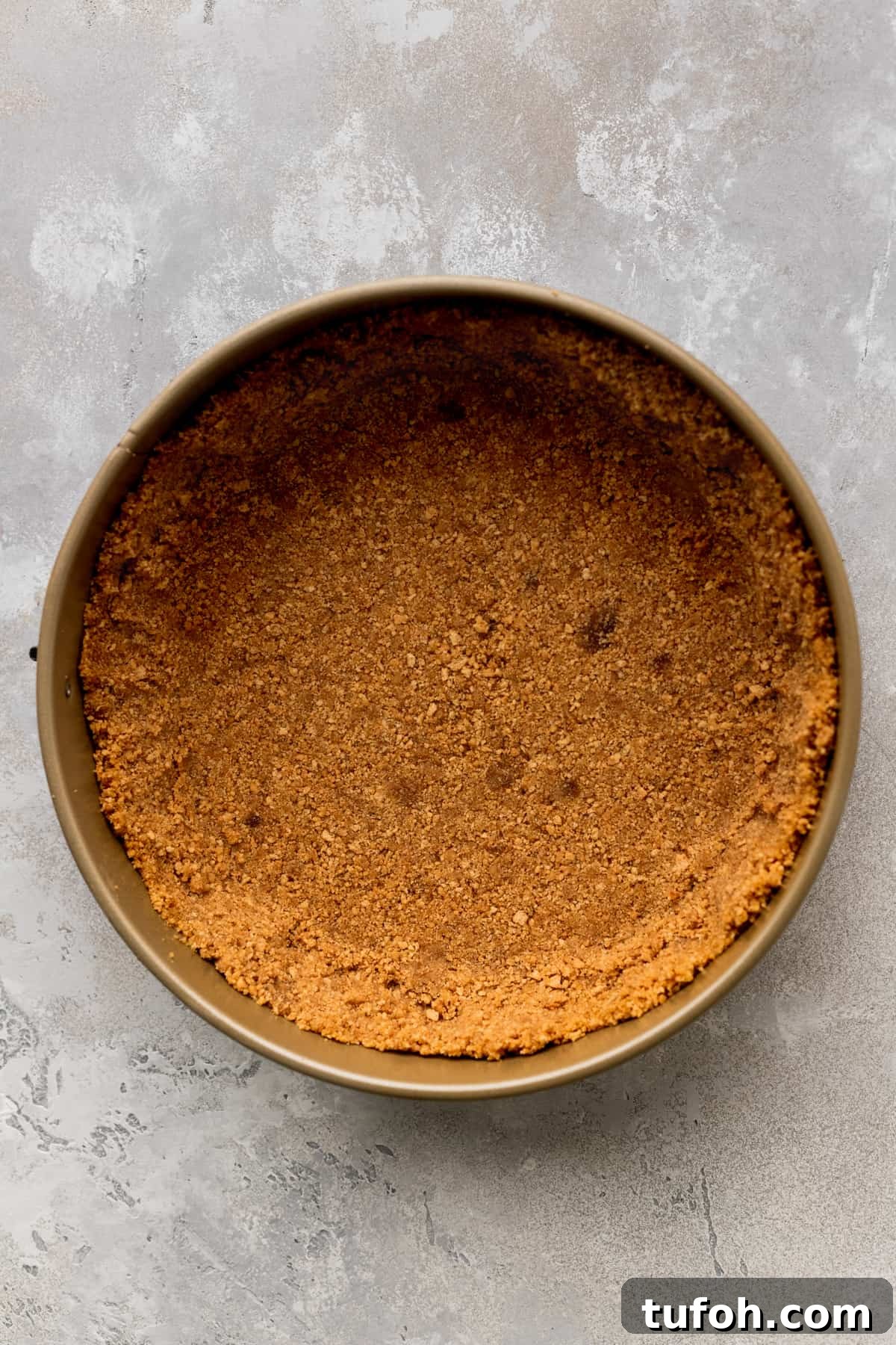 Decadent Honey Cheesecake Recipe with Silky Cream Filling 5 Graham cracker crust in a springform pan.