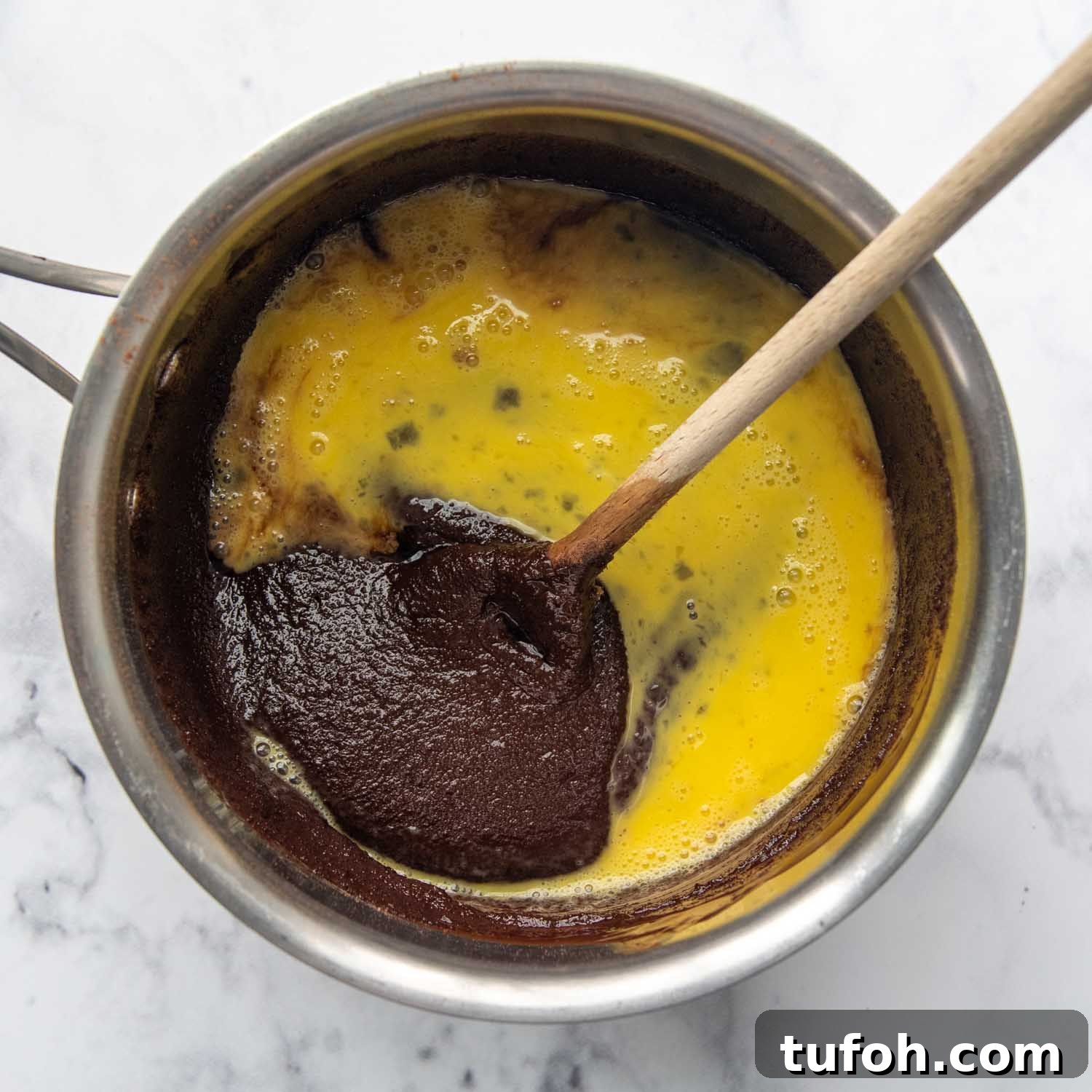Ultra-Fudgy Almond Flour Chocolate Brownies 5 eggs added to the saucepan.