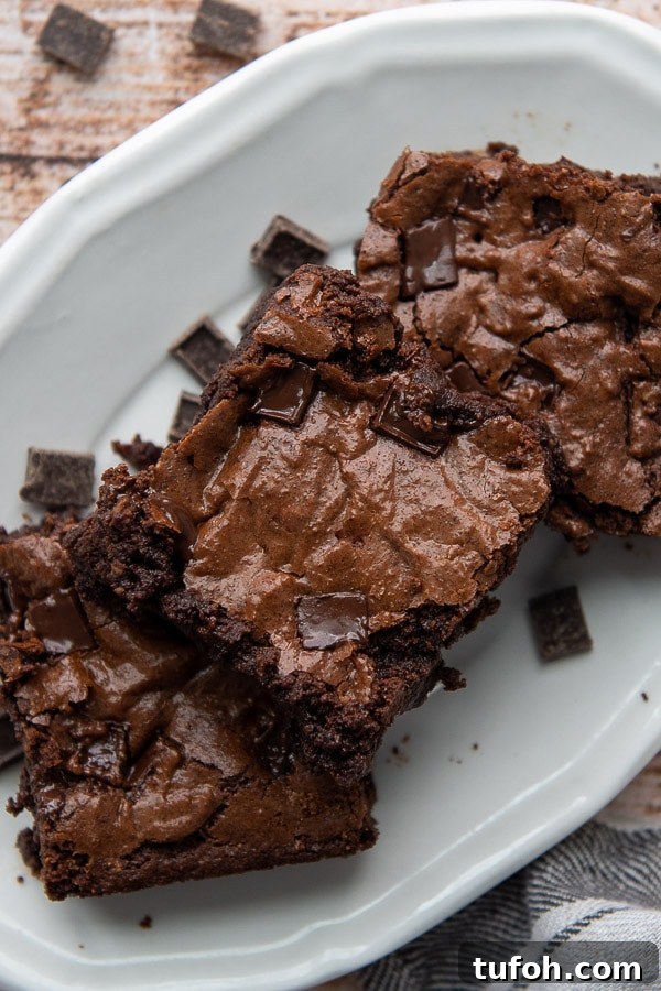 Ultra-Fudgy Almond Flour Chocolate Brownies 8 overhead shot of three almond flour brownies on a white plate