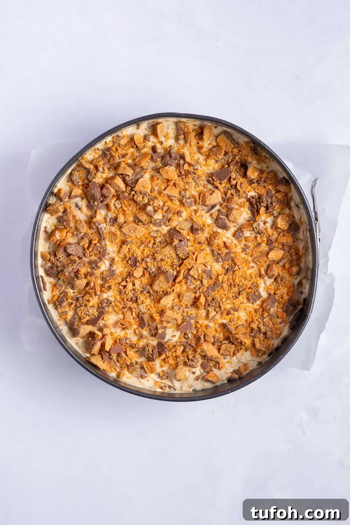chopped butterfinger candy bars sprinkled over the top of the pie