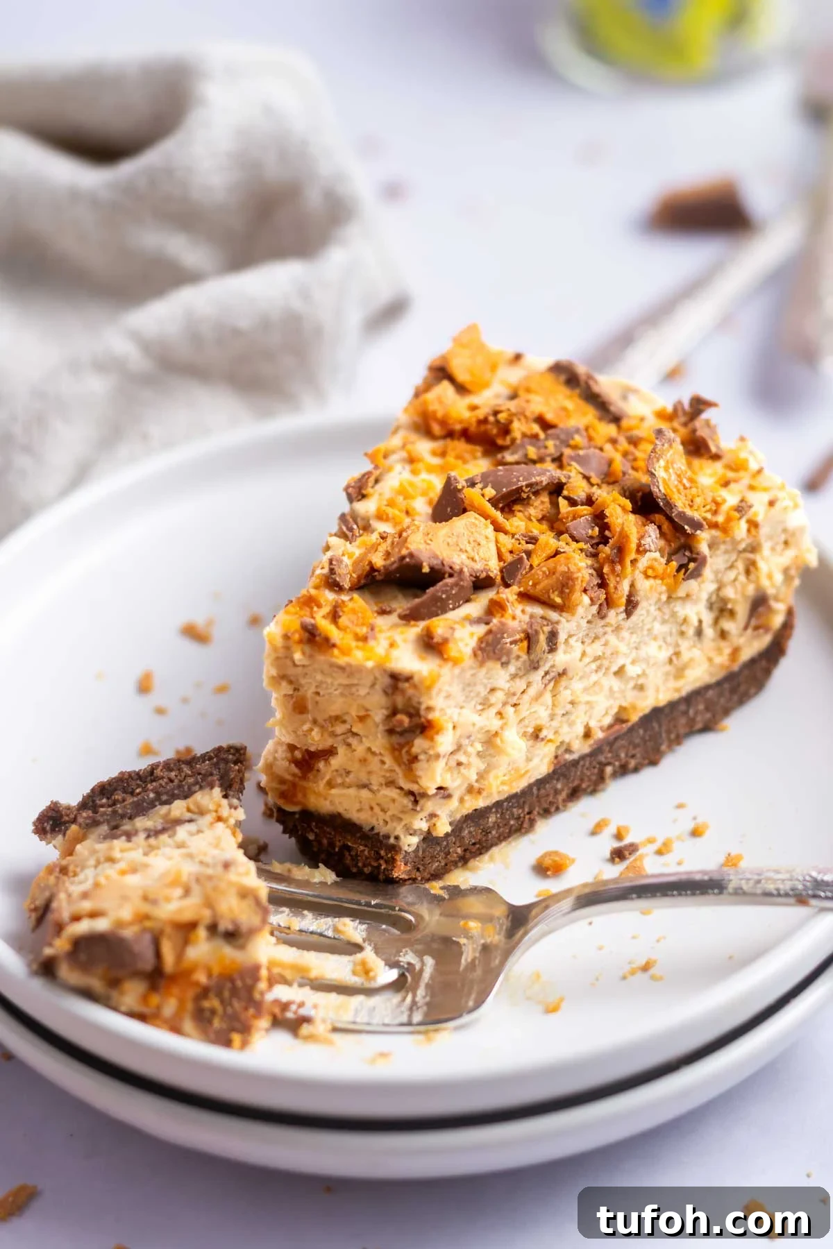 slice of butterfinger pie on a plate with a fork