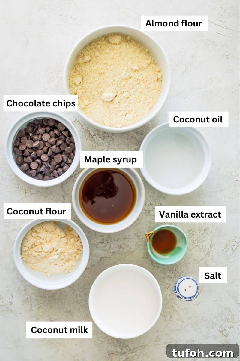 Different foods in bowls including almond flour, coconut flour, chocolate chips, coconut milk and coconut oil.