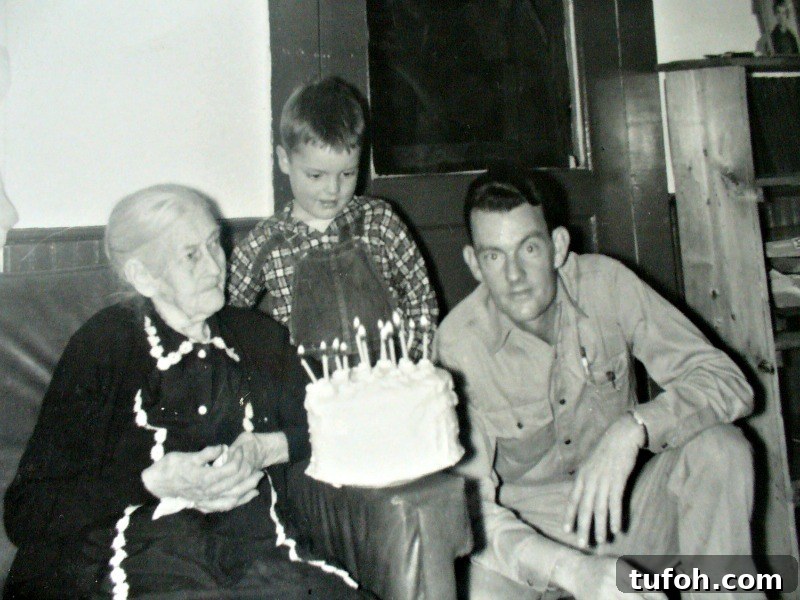Preserve Family Photos and Protect Your Family History 2 Black and white photo of elderly woman, young boy, man gathered around white birthday cake.