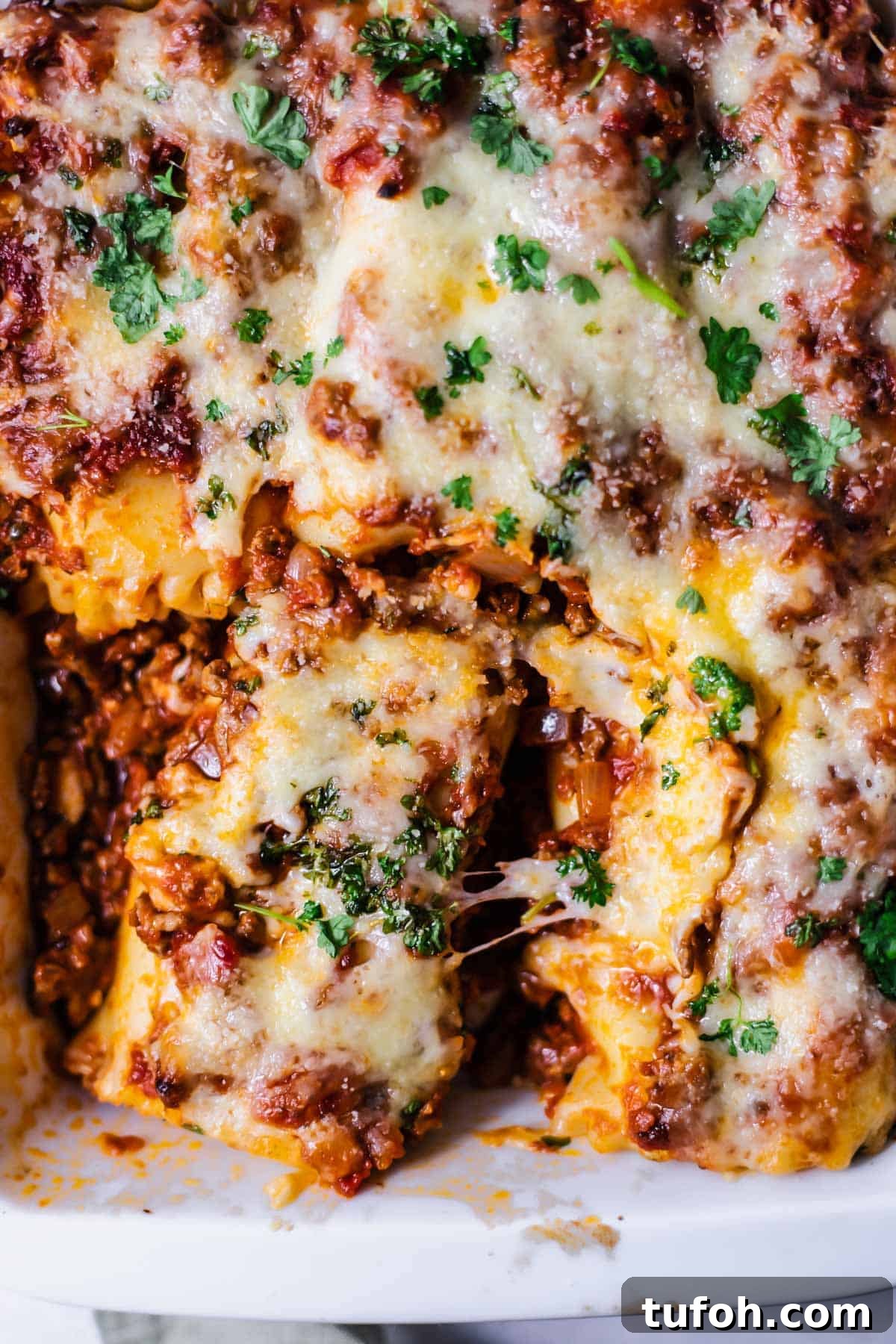 Cheesy Baked Lasagna Rolls with Marinara and Ricotta 2 close up image of baked lasagna rolls in a baking dish