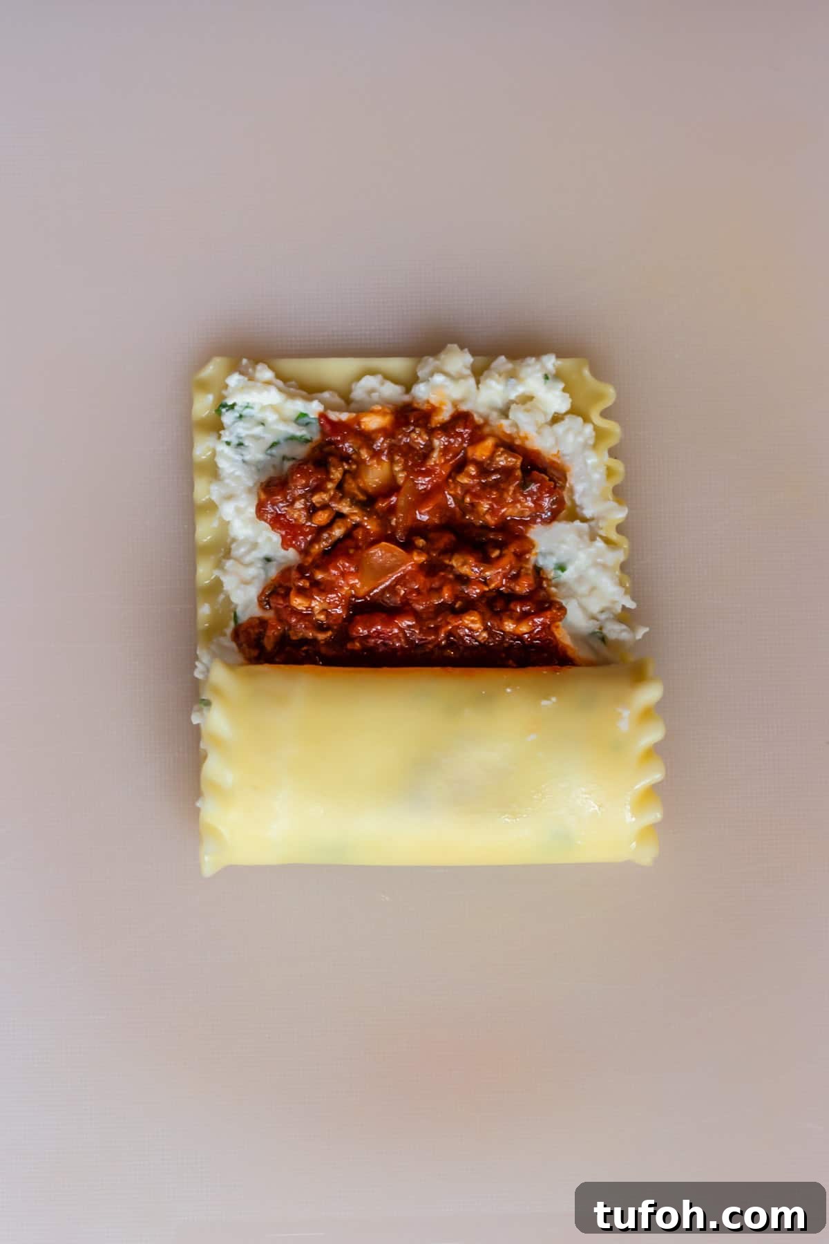 Cheesy Baked Lasagna Rolls with Marinara and Ricotta 6 a lasagna noodle layered with ricotta cheese and beef marinara sauce halfway rolled