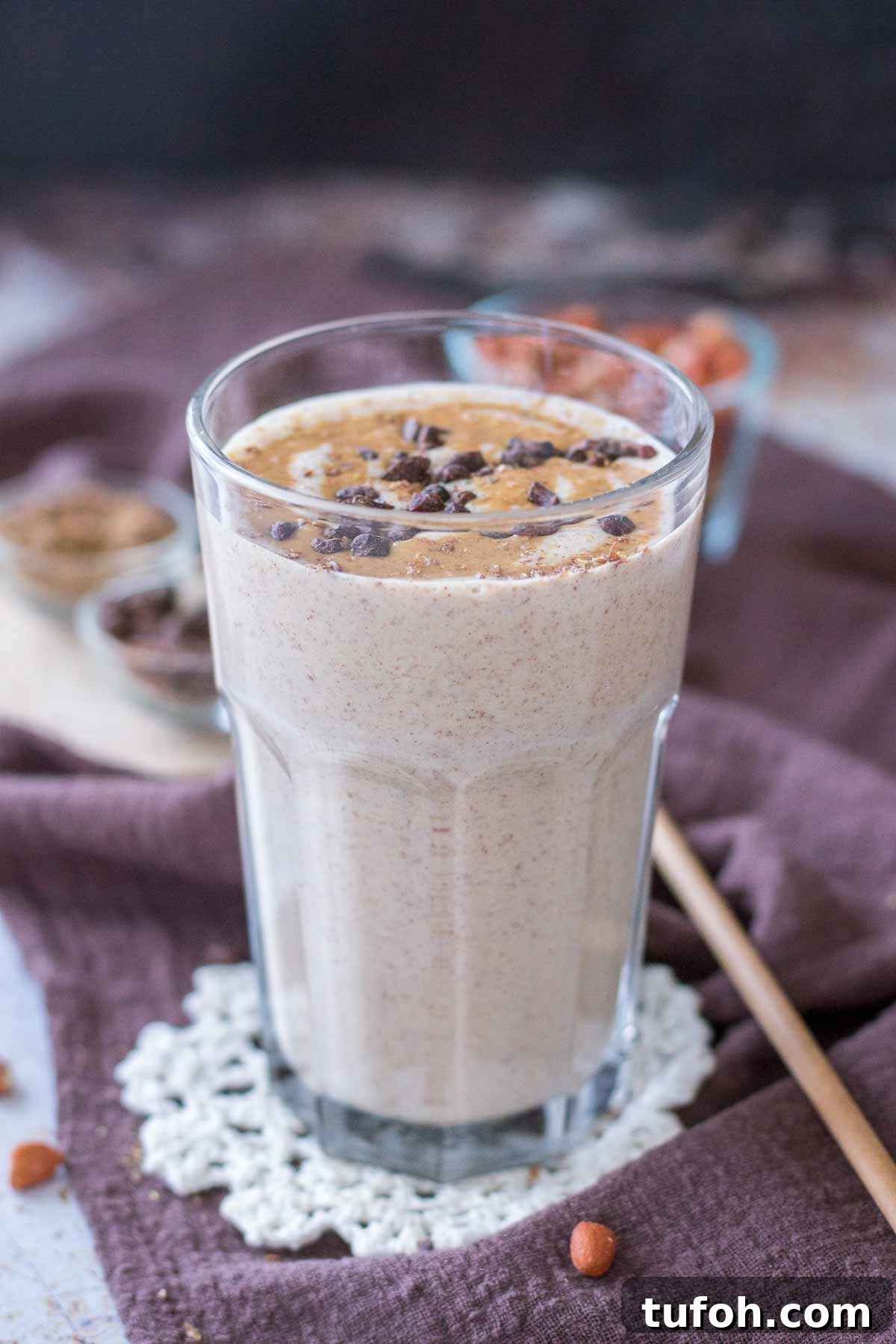 Peanut Butter Protein Shake in a glass topped with peanut butter and chocolate