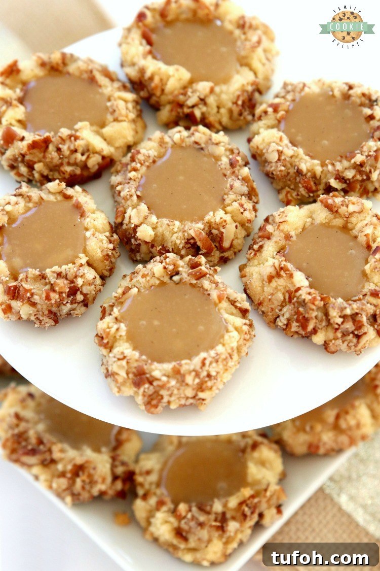 Caramel Thumbprint Cookies are a classic shortbread cookie rolled in pecans, baked & filled with warm caramel. Buttery Christmas cookies that everyone loves seeing at holiday cookie exchanges!