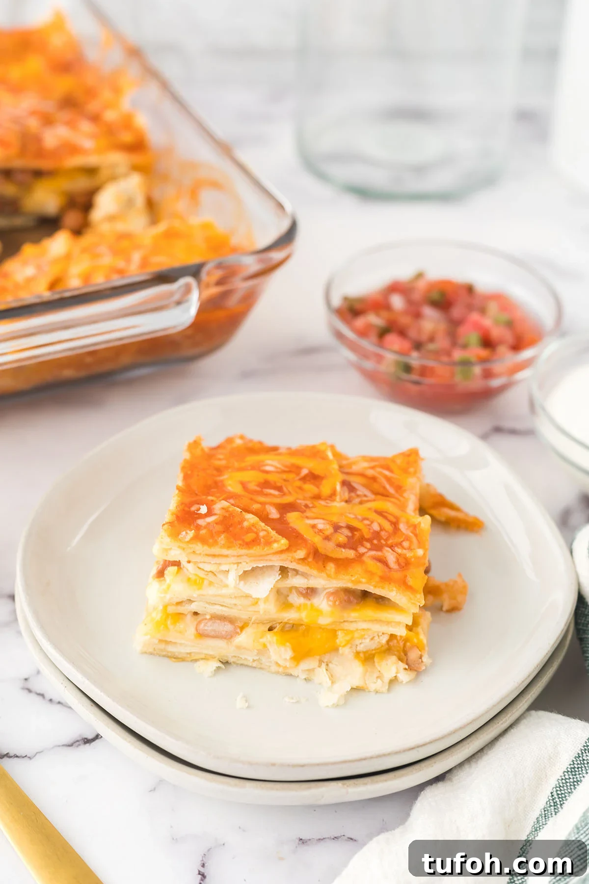Layered Chicken Enchilada Casserole Recipe — Cheesy Mexican Bake 2 Serving of Chicken Enchilada Casserole on plate.