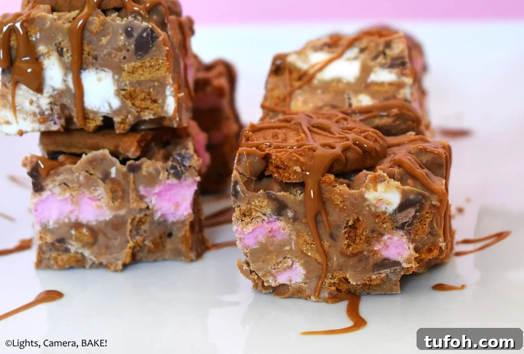 Biscoff Rocky Road Recipe: No-Bake Biscoff Chocolate Squares 3 Pieces of cookie butter slice on a white plate.
