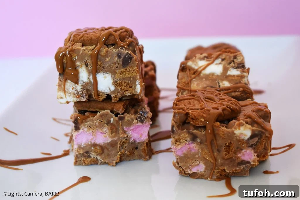 Biscoff Rocky Road Recipe: No-Bake Biscoff Chocolate Squares 5 Slices of cookie butter, marshmallow rocky road on a white plate.