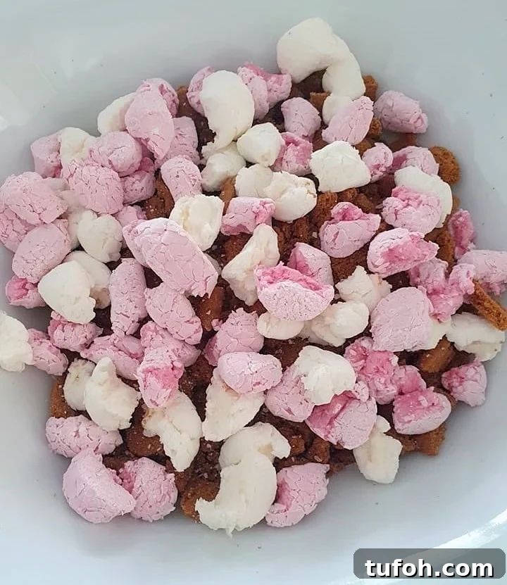Biscoff Rocky Road Recipe: No-Bake Biscoff Chocolate Squares 8 Marshmallows in a white bowl.