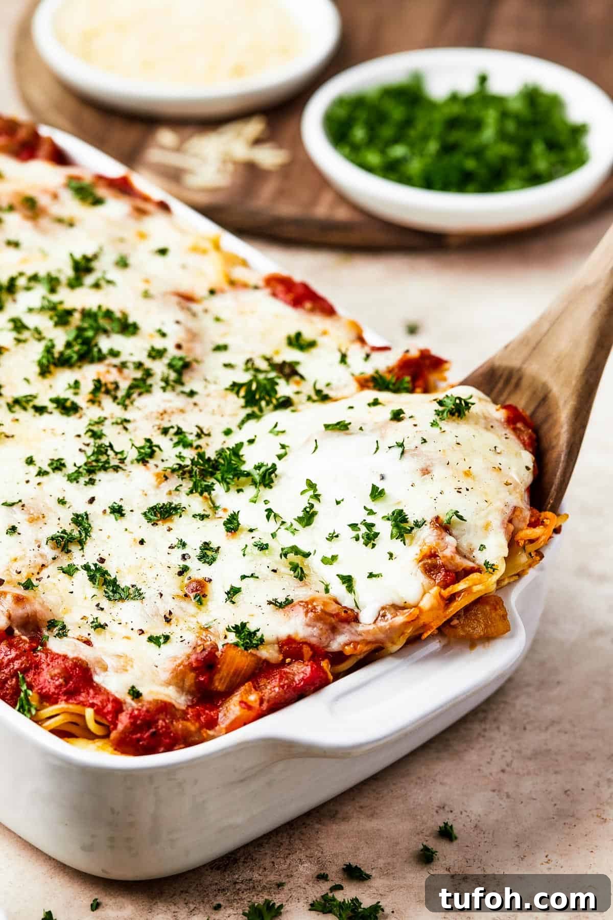 Ultimate Cheesy Baked Spaghetti Casserole Recipe 10 Spaghetti casserole in a white baking dish.