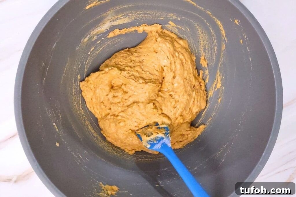 3-Ingredient Air Fryer Pumpkin Waffles for Fall Breakfast 5 combine pancake mix, pumpkin puree, and pumpkin spice in a bowl