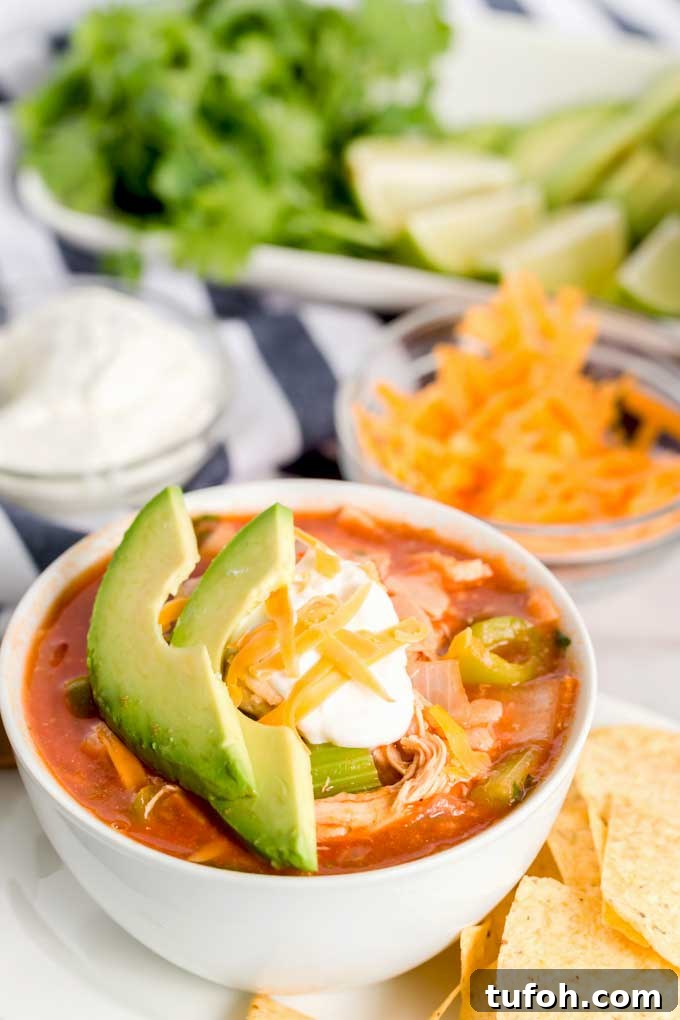 Comforting Chicken Tortilla Soup with Avocado and Crispy Tortillas 2 A white bowl filled with homemade Tortilla soup