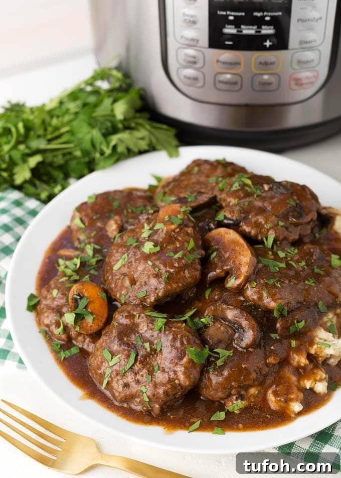 Salisbury Steaks on white plate on top of green gingham napkin