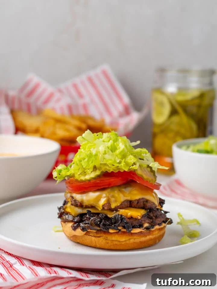Caramelized Onion Smash Burger — Next-Level Flavor 17 assembling the caramelized onion burger on a white plate