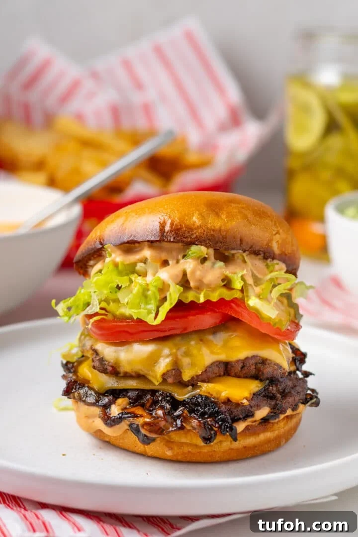 Caramelized Onion Smash Burger — Next-Level Flavor 19 close up view of a brioche bun, caramelized onions, burger patty, tomato, lettuce and special sauce