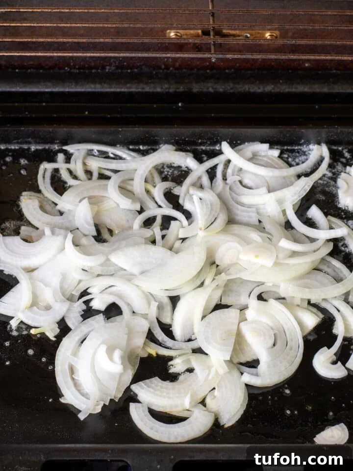 Caramelized Onion Smash Burger — Next-Level Flavor 7 thinly sliced sweet onions on a flat top grill
