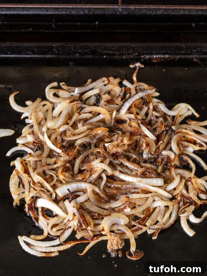 Caramelized Onion Smash Burger — Next-Level Flavor 8 brown sugar and balsamic vinegar added to sliced onions on a grill