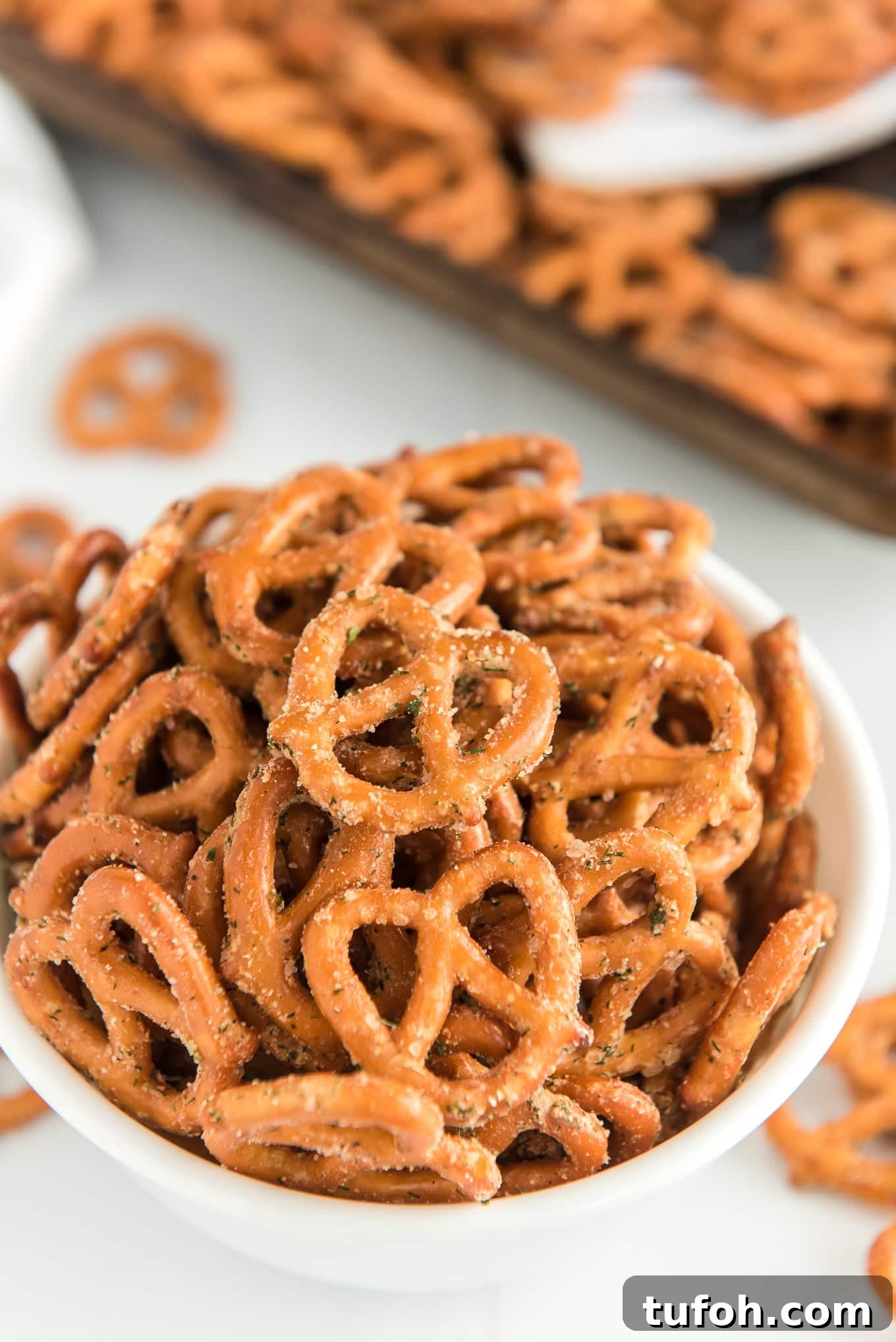 Crunchy Ranch Pretzel Bites: Savory Snack Recipe 7 Bowl of seasoned pretzels with a sheet pan in the background.