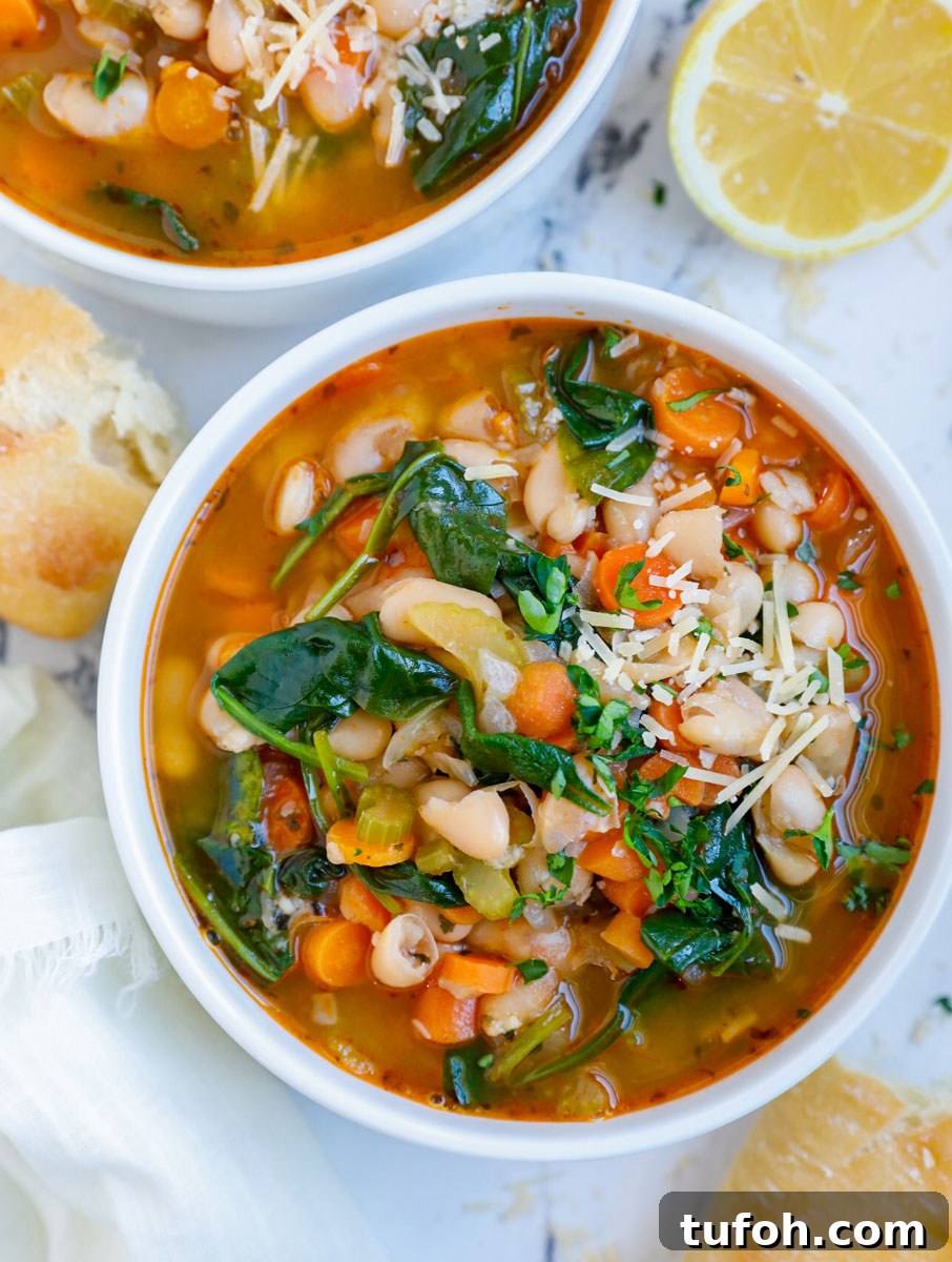 Overhead photo of a bowl of white bean soup with bread beside it.