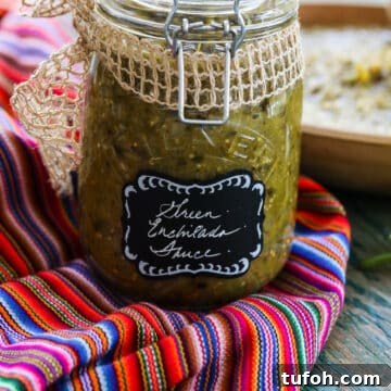 Cheesy Chicken Enchilada Casserole Recipe for Family Dinner 4 A glass jar with a clamp filled with green enchilada sauce on a colorful striped piece of cloth.
