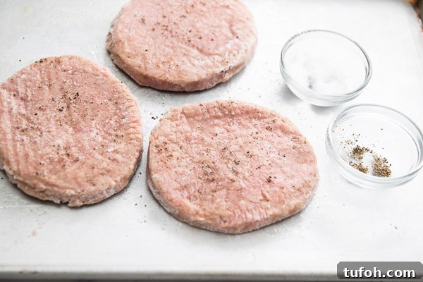 Crispy Air Fryer Frozen Turkey Patties in 12–15 Minutes 9 Season frozen turkey Pattie on a cutting board