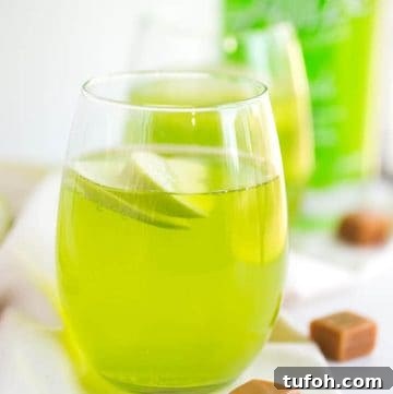 caramel apple cocktail on a white fabric with caramels