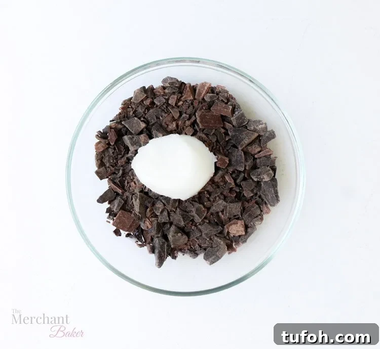 Chocolate Shell Ice Cream Topping: Crunchy Hard Chocolate Coating 7 Chocolate chunks and coconut oil in a glass bowl from themerchantbaker.com