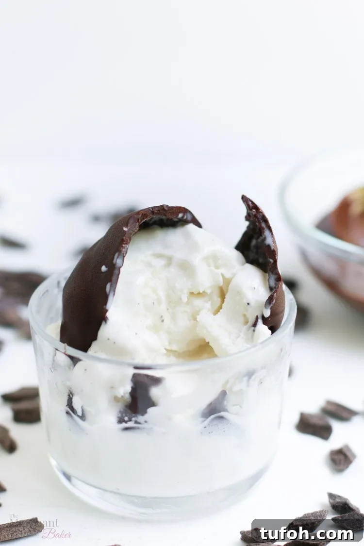 Chocolate Shell Ice Cream Topping: Crunchy Hard Chocolate Coating 13 Chocolate hard shell ice cream topping cracked open on a scoop of vanilla ice cream from themerchantbaker.com