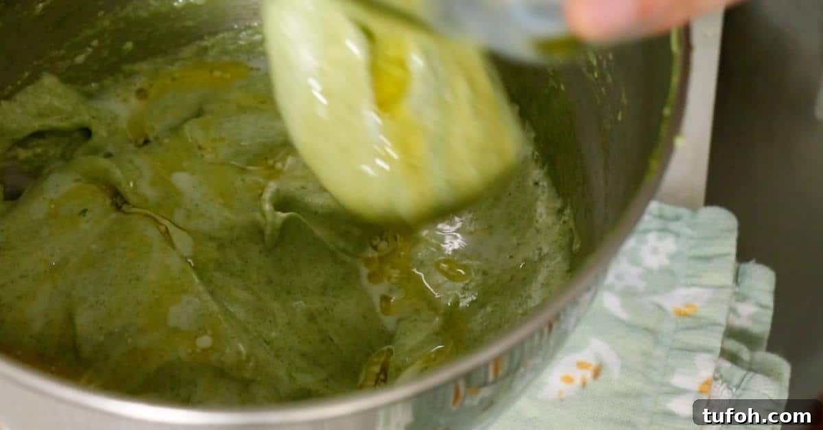 adding oil and milk in matcha sponge batter