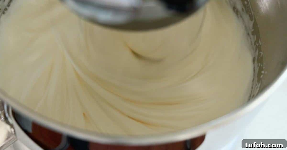 mixing sugar and egg in a mixing bowl