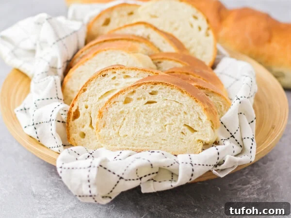 A sliced loaf of Italian bread in a basket.