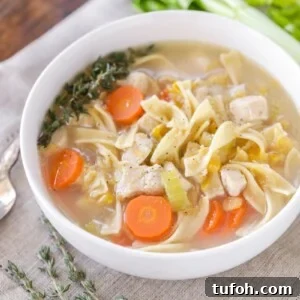 Chicken corn soup served in a white bowl.