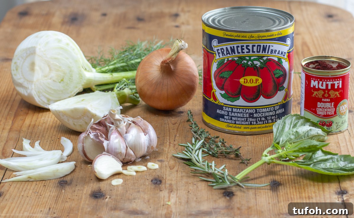 Ingredients for Tomato fennel Soup on a vintage wood board 