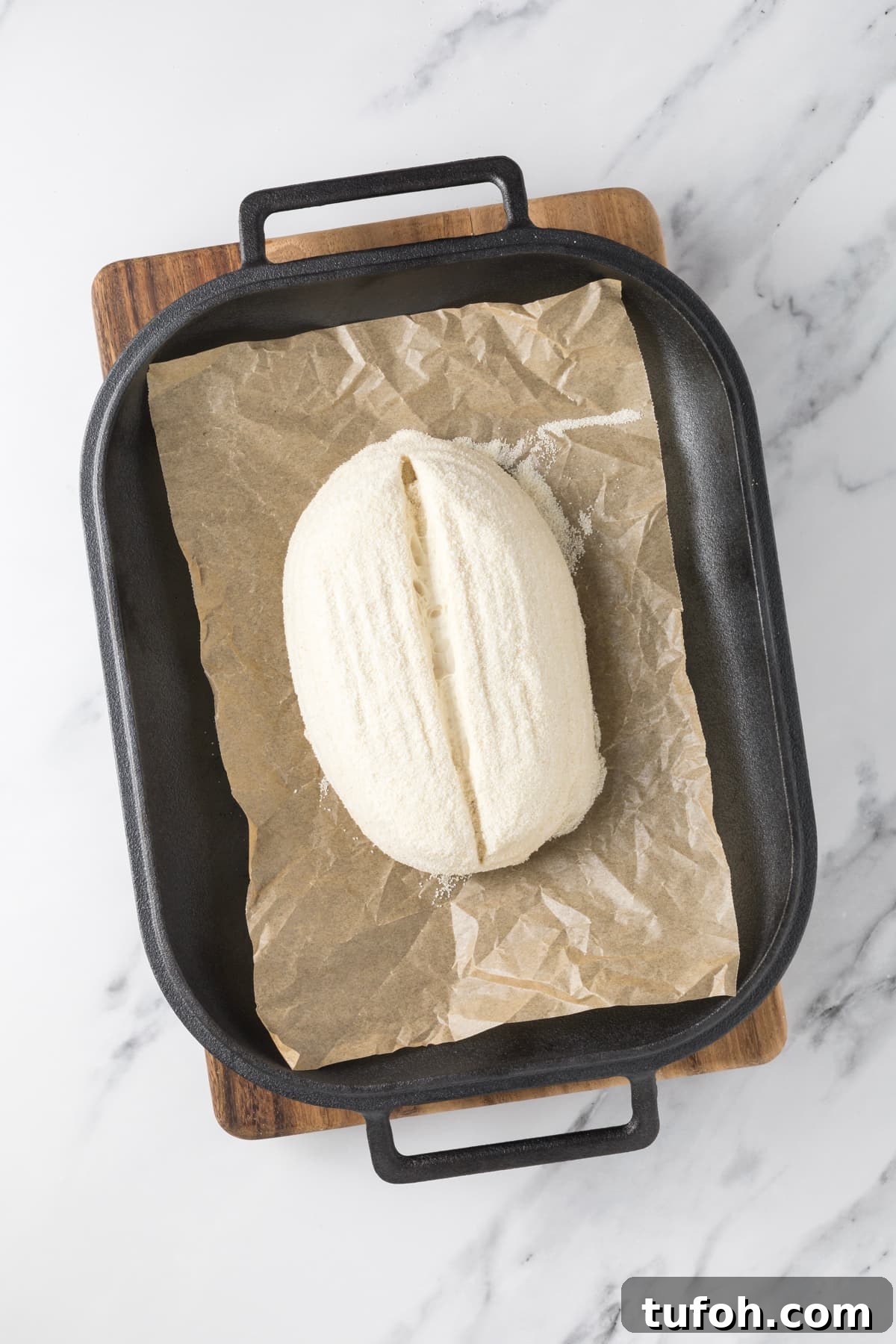 Small-Batch Sourdough Loaf Recipe for Home Bakers 11 Top view of proofed small batch sourdough bread dough in bread pan ready to bake.