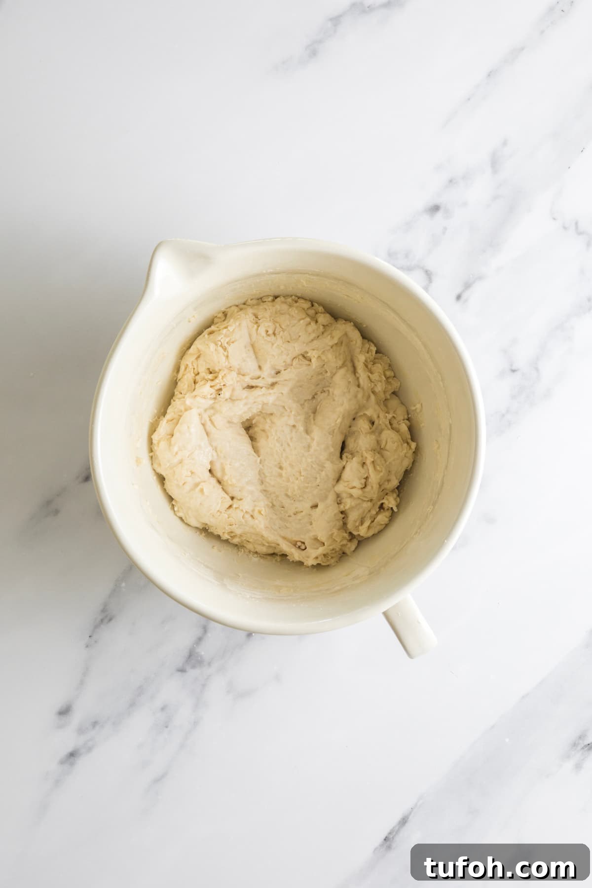 Small-Batch Sourdough Loaf Recipe for Home Bakers 4 Shaggy small batch sourdough bread dough resting in a ceramic mixing bowl after the initial mix.