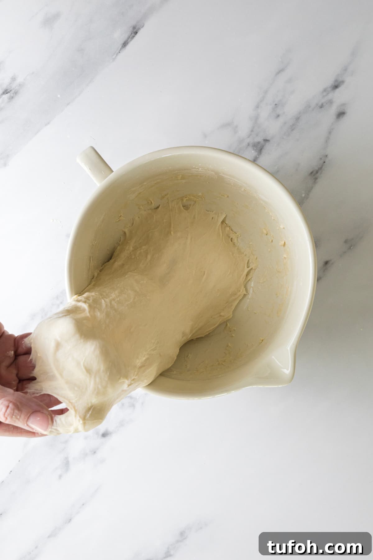 Small-Batch Sourdough Loaf Recipe for Home Bakers 6 Stretching small batch sourdough bread dough during the stretch and fold process.