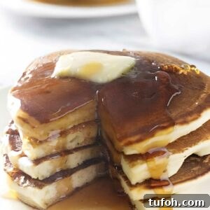 Stack of sourdough ricotta pancakes with butter.
