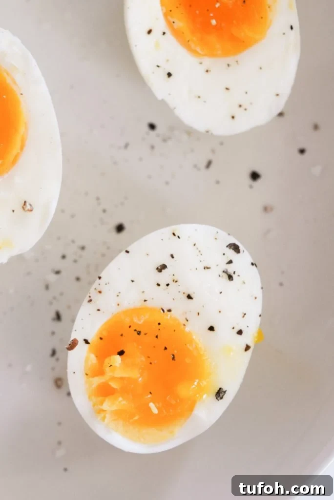 Perfect Jammy Eggs: Soft-Boiled Recipe for Runny Yolks 12 perfect jammy eggs cut in half on a plate