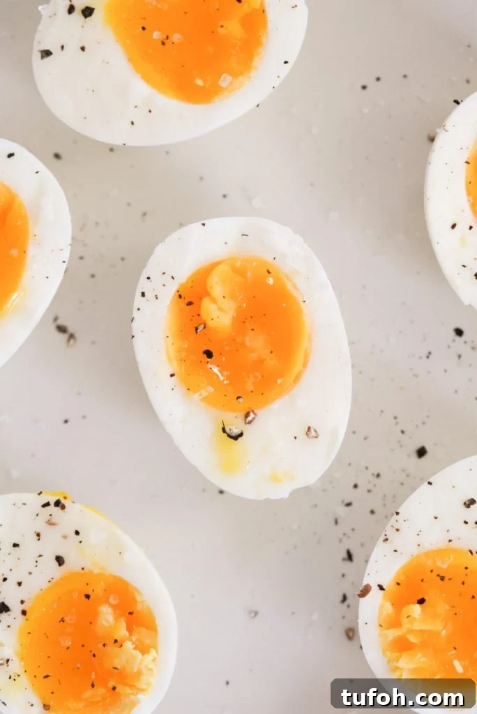 Perfect Jammy Eggs: Soft-Boiled Recipe for Runny Yolks 3 a plate of 7 minute eggs topped with salt and cracked black pepper