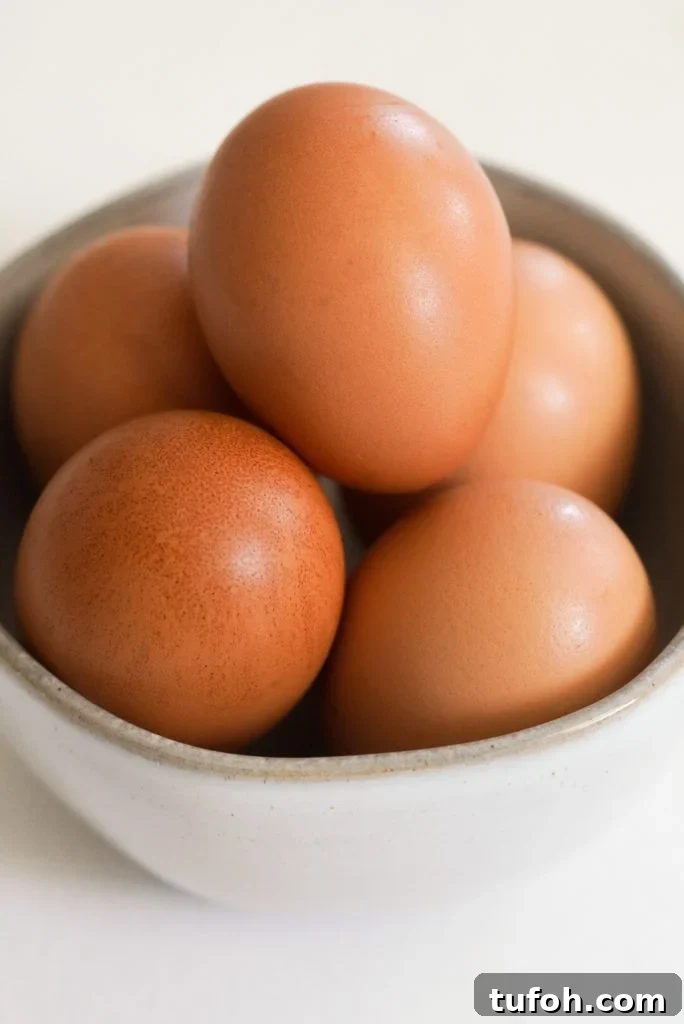Perfect Jammy Eggs: Soft-Boiled Recipe for Runny Yolks 4 a small bowl of brown eggs