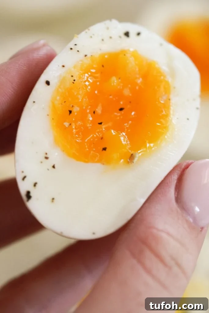 Perfect Jammy Eggs: Soft-Boiled Recipe for Runny Yolks 10 hand holding a jelly jam-like egg half