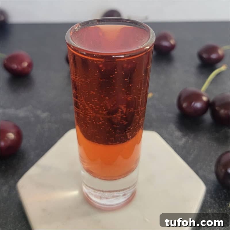 25+ Romantic Valentine's Day Cocktails and Toasting Drinks 20 Red shot surrounded by cherries