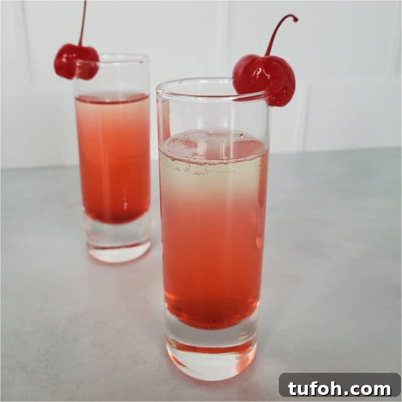 25+ Romantic Valentine's Day Cocktails and Toasting Drinks 22 layered red cocktail garnished with cherries