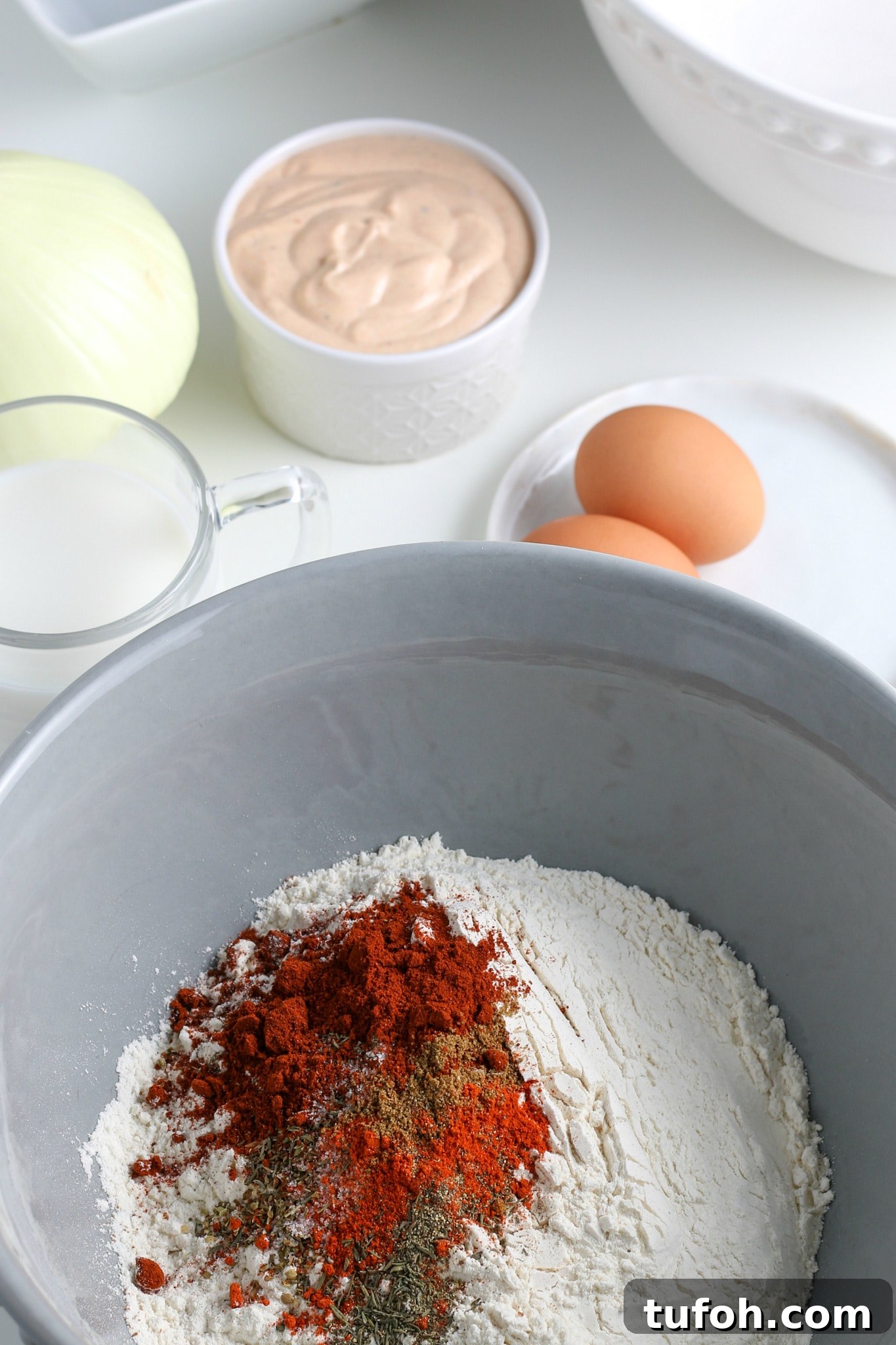 Crispy Air Fryer Bloomin' Onion Recipe for Game Day 8 flour and spices in a large mixing bowl.
